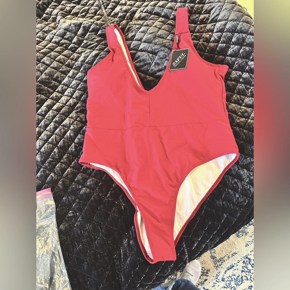 Deep red one piece bathing suit. Brand new with tags.